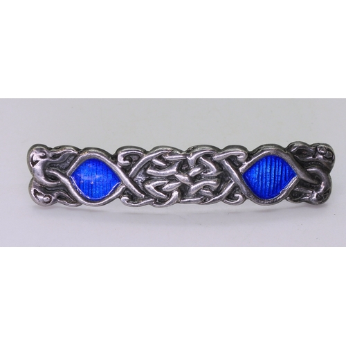 2822 - TWO ALEXANDER RITCHIE JEWELSan early brooch, with blue enamel among the knotwork and four zoomorphic... 