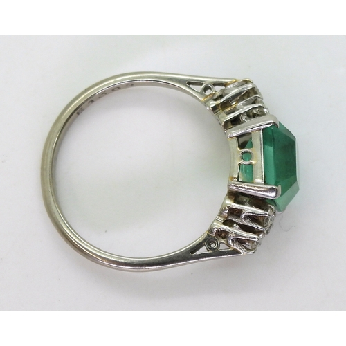 2826 - AN EMERALD AND DIAMOND RINGset in 18ct white gold and platinum, with a step cut emerald of approx 8.... 