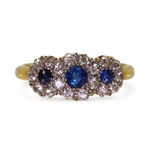 2827 - A THREE FLOWER CLUSTER RINGset with three round cut sapphires surrounded with old cut diamonds with ... 