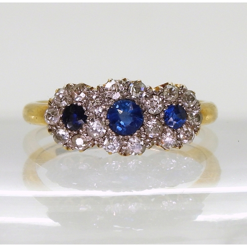 2827 - A THREE FLOWER CLUSTER RINGset with three round cut sapphires surrounded with old cut diamonds with ... 