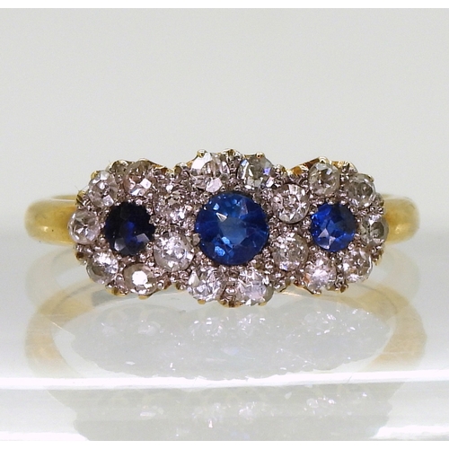 2827 - A THREE FLOWER CLUSTER RINGset with three round cut sapphires surrounded with old cut diamonds with ... 