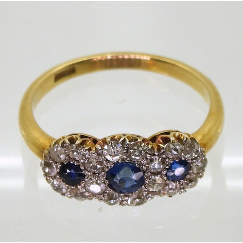 2827 - A THREE FLOWER CLUSTER RINGset with three round cut sapphires surrounded with old cut diamonds with ... 