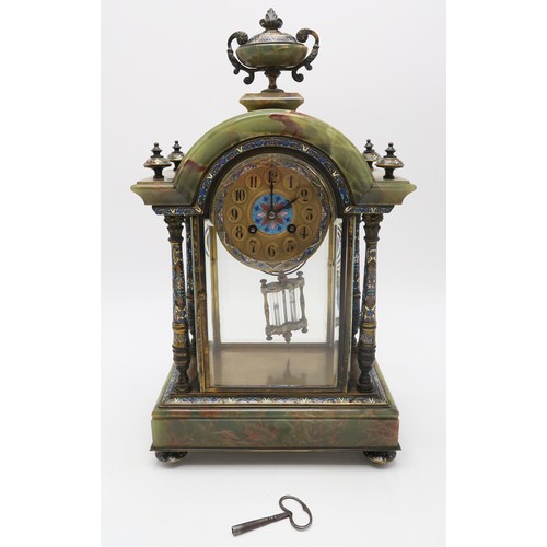 2270 - A FRENCH CHAMPLEVE ENAMEL AND ONYX CLOCK GARNITUREthe domed top with urn above, with four supporting... 