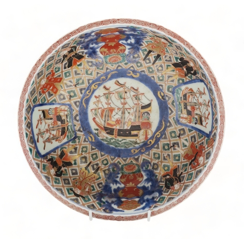 2393 - AN IMARI 'BLACK SHIP' BOWLdecorated with ships and figures on a diaper pattern ground, 25.5cm diamet... 