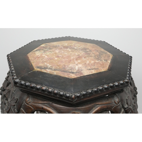 2395 - A CHINESE CARVED HARDWOOD MARBLE STANDthe circular top above four openwork foliate carved aprons, wi... 