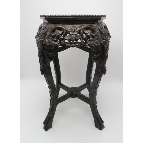 2395 - A CHINESE CARVED HARDWOOD MARBLE STANDthe circular top above four openwork foliate carved aprons, wi... 