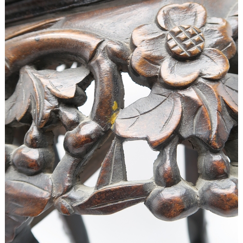 2395 - A CHINESE CARVED HARDWOOD MARBLE STANDthe circular top above four openwork foliate carved aprons, wi... 