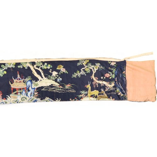 2397 - A CHINESE BLUE GROUND SILK EMBROIDERED PANELdepicting cranes and deer amongst peaches, pine trees, p... 