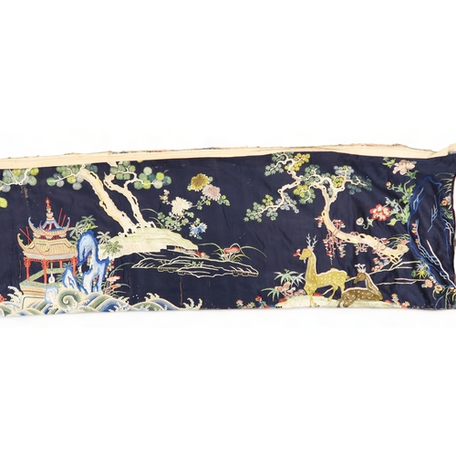 2397 - A CHINESE BLUE GROUND SILK EMBROIDERED PANELdepicting cranes and deer amongst peaches, pine trees, p... 