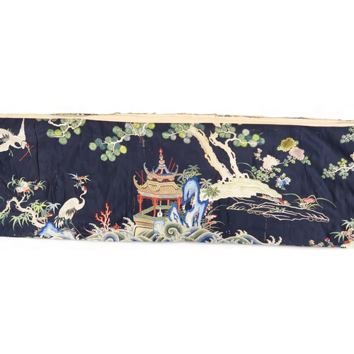 2397 - A CHINESE BLUE GROUND SILK EMBROIDERED PANELdepicting cranes and deer amongst peaches, pine trees, p... 