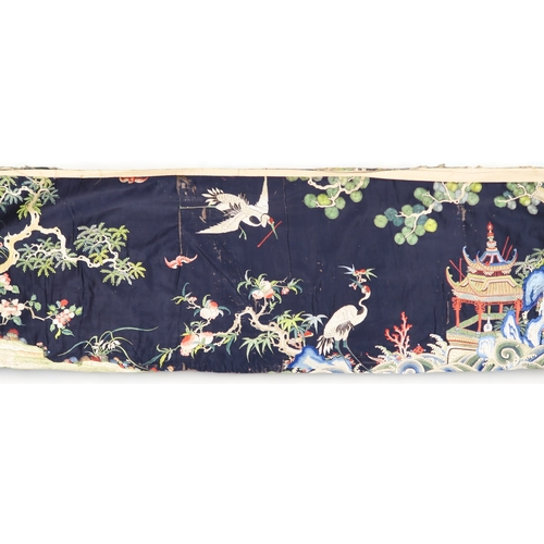 2397 - A CHINESE BLUE GROUND SILK EMBROIDERED PANELdepicting cranes and deer amongst peaches, pine trees, p... 