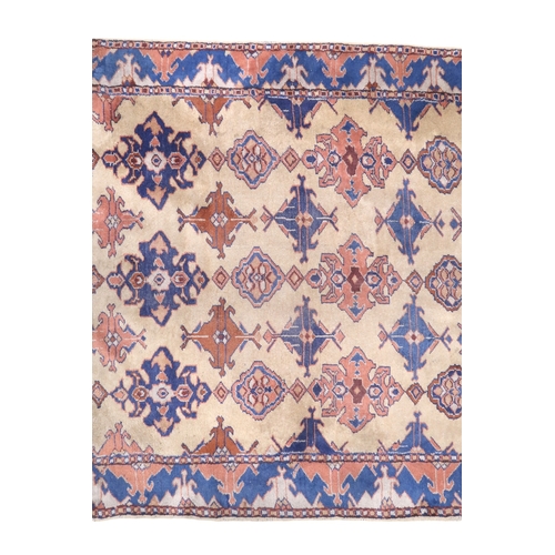 2140 - A LARGE BEIGE GROUND MALAYER RUNNER with multicoloured medallions and geometric borders, 647cm ... 