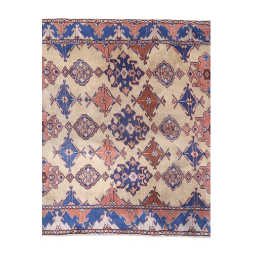 2140 - A LARGE BEIGE GROUND MALAYER RUNNER with multicoloured medallions and geometric borders, 647cm ... 