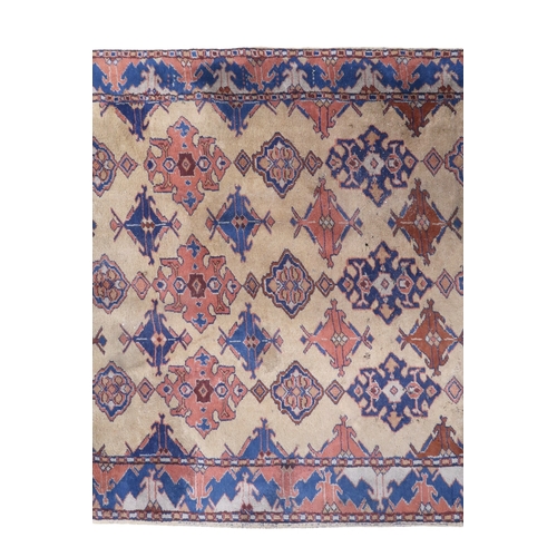 2140 - A LARGE BEIGE GROUND MALAYER RUNNER with multicoloured medallions and geometric borders, 647cm ... 