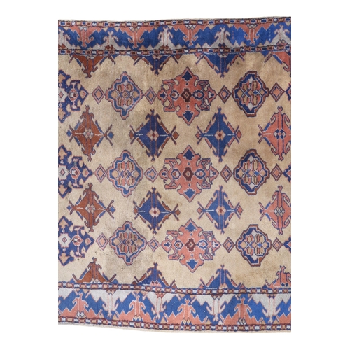 2140 - A LARGE BEIGE GROUND MALAYER RUNNER with multicoloured medallions and geometric borders, 647cm ... 