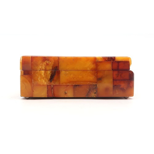 2601A - AN AMBER-TILED CIGARETTE BOXWith plaque affixed to base reading 