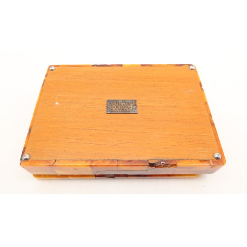 2601A - AN AMBER-TILED CIGARETTE BOXWith plaque affixed to base reading 