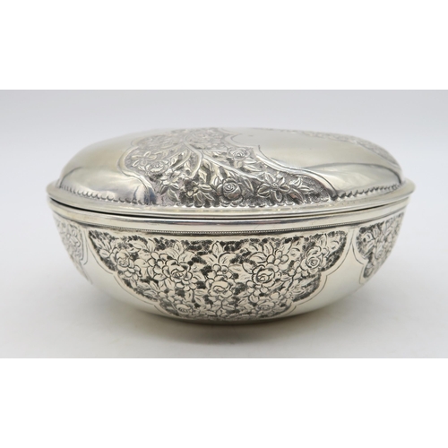 354 - A stamped 800 white metal bowl and cover, with alternating panels of embossed foliage, 18cm diameter... 