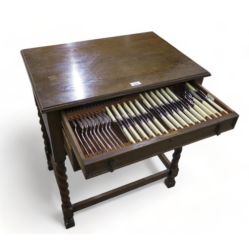 A two drawer oak canteen of stainless steel ivorine handled cutlery, by