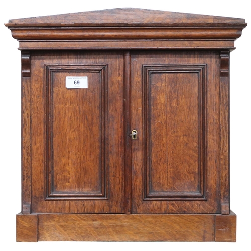 69 - A late Victorian oak architectural style collectors cabinet with pair of cabinet doors concealing fi... 