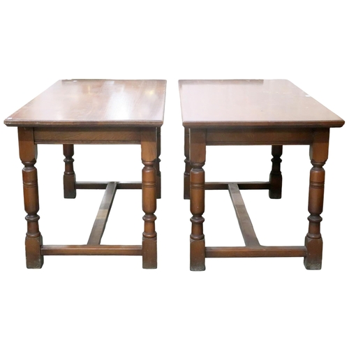 72 - A pair of early 20th century oak library tables with rectangular tops on turned supports joined by s... 