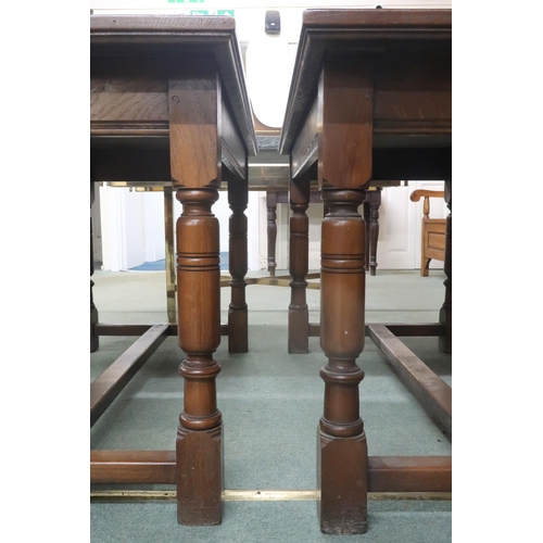 72 - A pair of early 20th century oak library tables with rectangular tops on turned supports joined by s... 