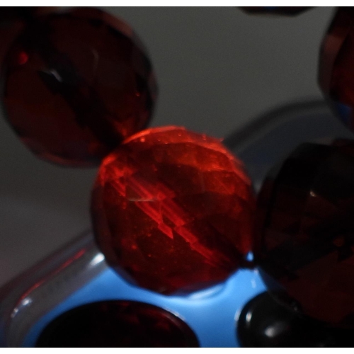 721 - A string of faceted cherry amber coloured beads, the largest is 18.5mm, and the smallest 7.3mm, tota... 