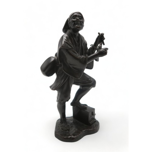 2396A - A JAPANESE BRONZE MODEL OF A MUSICIANstanding and with instrument slung over his shoulder and with o... 