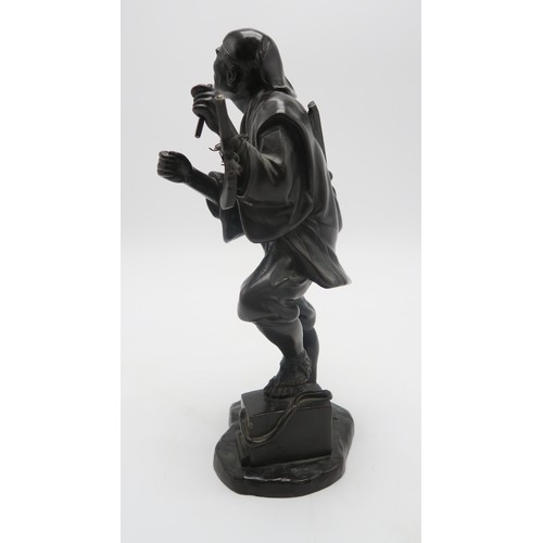 2396A - A JAPANESE BRONZE MODEL OF A MUSICIANstanding and with instrument slung over his shoulder and with o... 