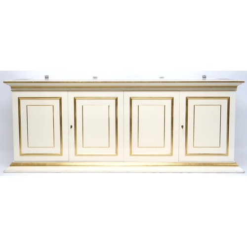 118 - A CONTEMPORARY GILT WHITE VERSACE MIRROR BACK SIDEBOARD mirror with gilt moulded cornice over rectan... 