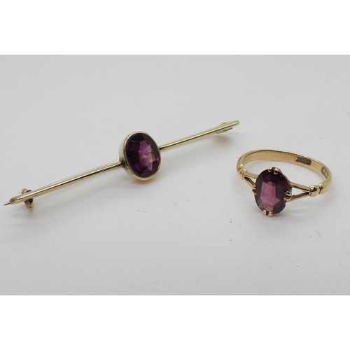 717 - An 18ct gold garnet set ring, size L, together with a similar yellow metal brooch weight together 5g... 