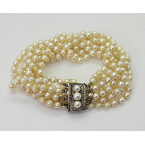 718 - A four strand cultured pearl necklace, with a silver and pearl clasp, length of shortest length 47cm... 