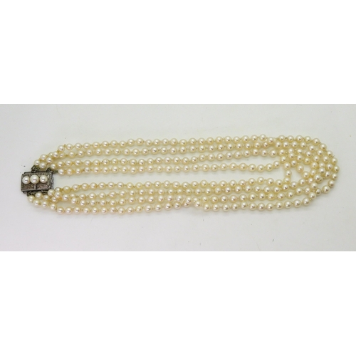 718 - A four strand cultured pearl necklace, with a silver and pearl clasp, length of shortest length 47cm... 