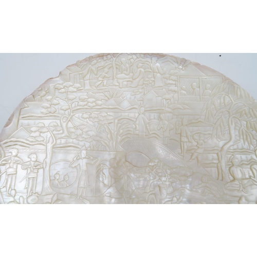 246 - A Chinese carved mother of pearl shell, decorated with figures and trees