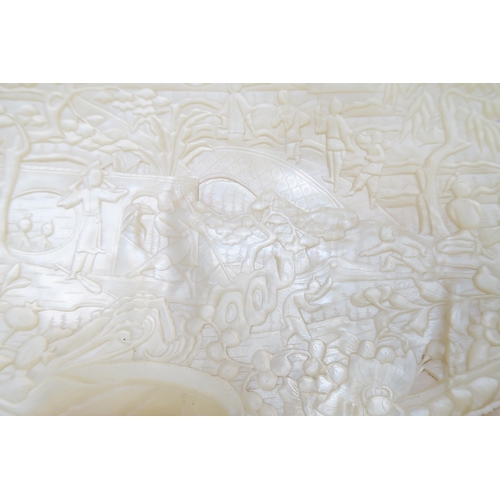 246 - A Chinese carved mother of pearl shell, decorated with figures and trees