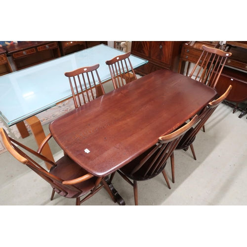 100 - A mid 20th century Ercol stained elm and beech Ercol dining table and six chairs, table with shaped ... 