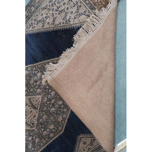 110 - A dark blue ground Sarouk rug with beige geometric central medallion, matching spandrels and geometr... 