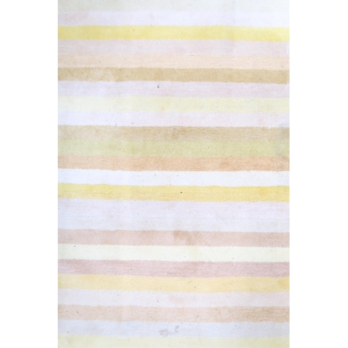 139 - A contemporary yellow candy stripe patterned wool pile rug, 272cm long x 182cm wide