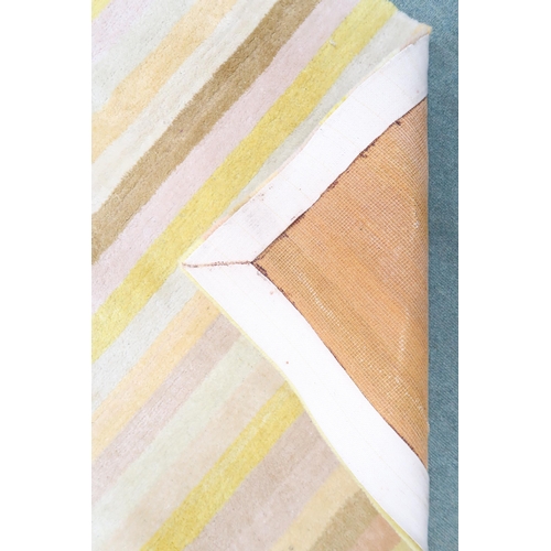 139 - A contemporary yellow candy stripe patterned wool pile rug, 272cm long x 182cm wide