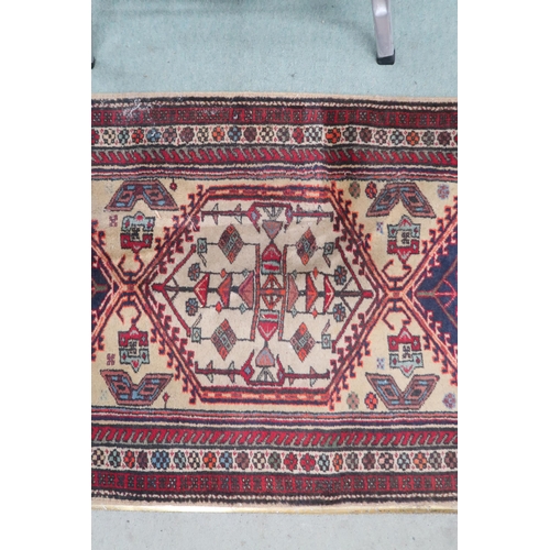 142 - A cream ground Caucasian style runner with multicoloured diamond shaped medallions withing multicolo... 