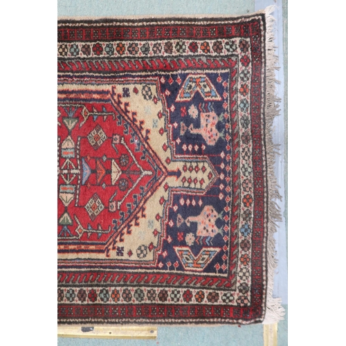 142 - A cream ground Caucasian style runner with multicoloured diamond shaped medallions withing multicolo... 