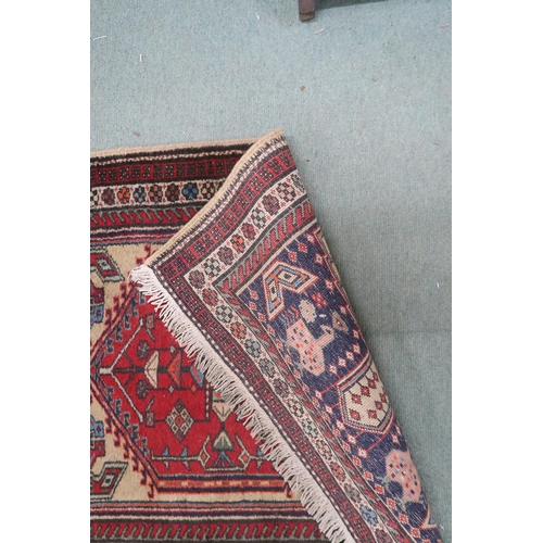 142 - A cream ground Caucasian style runner with multicoloured diamond shaped medallions withing multicolo... 