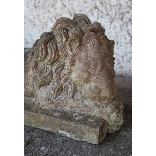 145 - A pair of 20th century stoneware garden statues of sleeping lions, 21cm high x 49cm long x 20cm deep... 