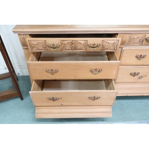 29 - A 20th century pine mirrored back bank of drawers with foliate carved bevelled mirror back on base w... 