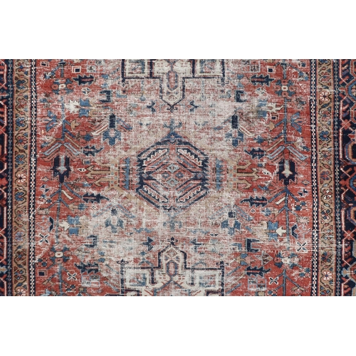 51 - A red ground Caucasian rug with two geometric medallions within multicoloured borders, 176cm long x ... 