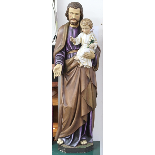 58 - A 20th century painted religious statue depicting St Joseph holding an infant Jesus on octagonal pli... 