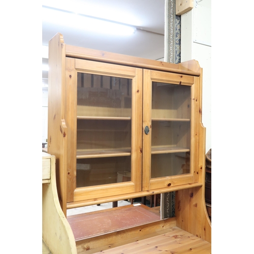 64 - A contemporary pine Range style bookcase with pair of glazed doors over pair of cabinet doors, 199cm... 