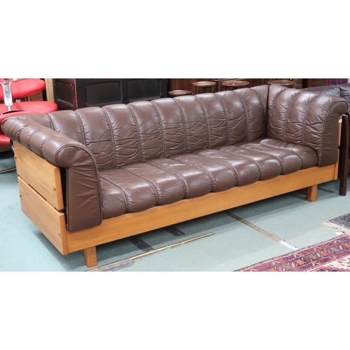 80 - A mid 20th century brown leather upholstered after Ekornes three seater settee with teak frame, 75cm... 