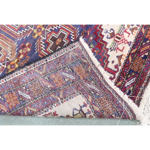 82 - A light blue ground Hamadan rug with geometric central medallion, cream spandrels and multicoloured ... 