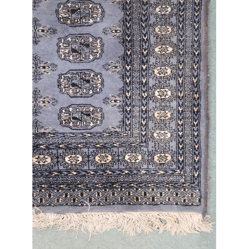 83 - A dark blue ground Bokhara style rug with all over lozenge design within geometric border, 159cm lon... 